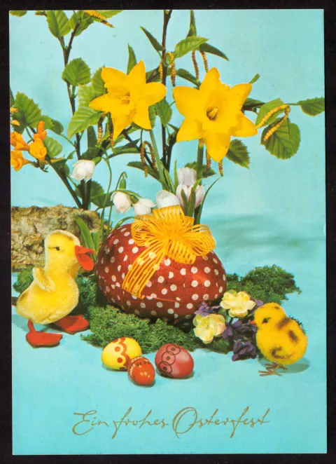 Easter greeting with chicks, eggs and flowers
